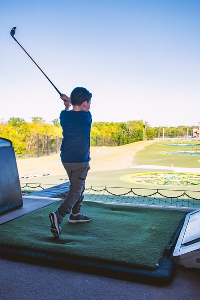 Wearing blue shirt and black pants man armed with a golf club
